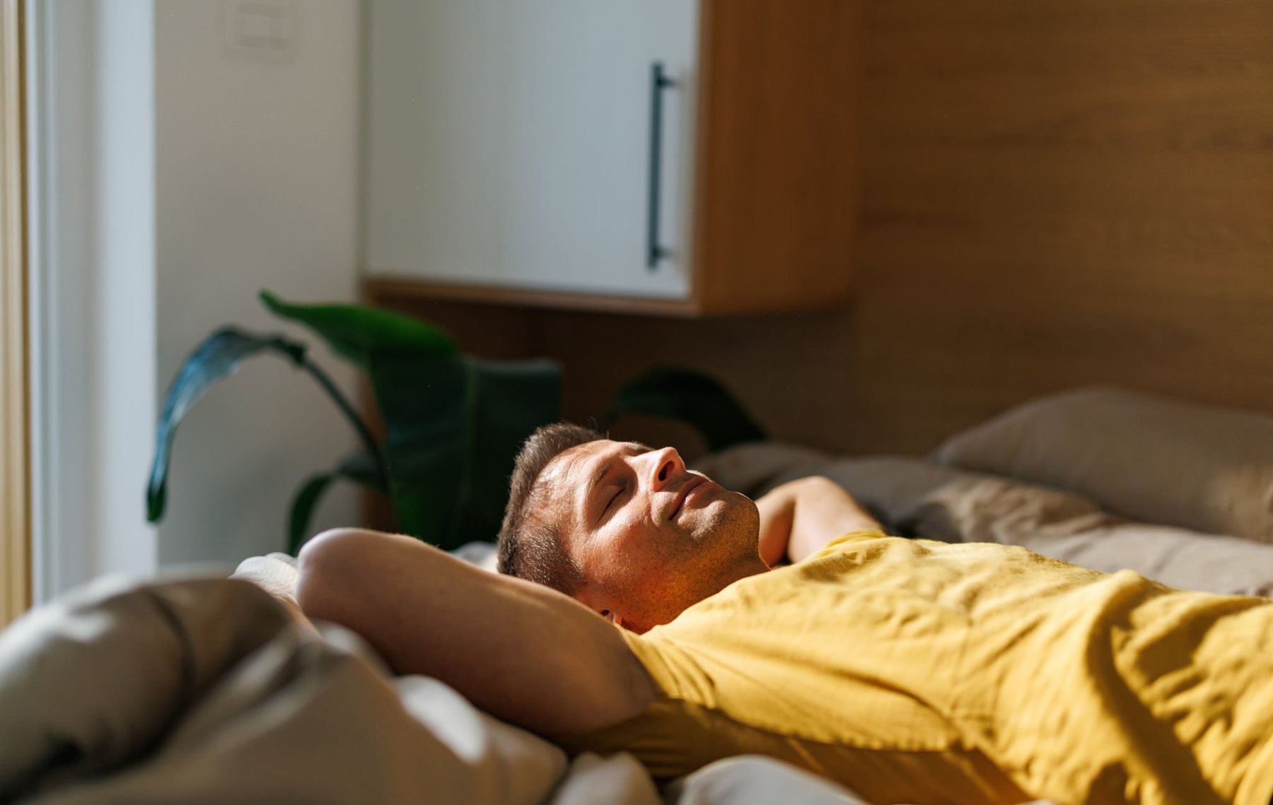 A person at home in the evening, phone in hand