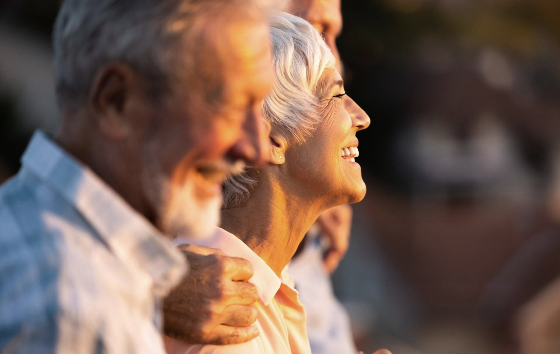 An older couple outdoors in warm evening light